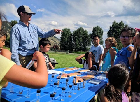 JHFFS instructor teaches future anglers about trout diet from the riverbed up.